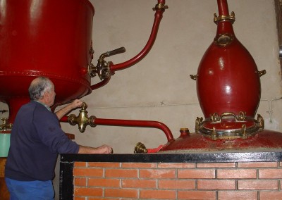 A distiller facing his traditional still with an olive shape head capital for cognac