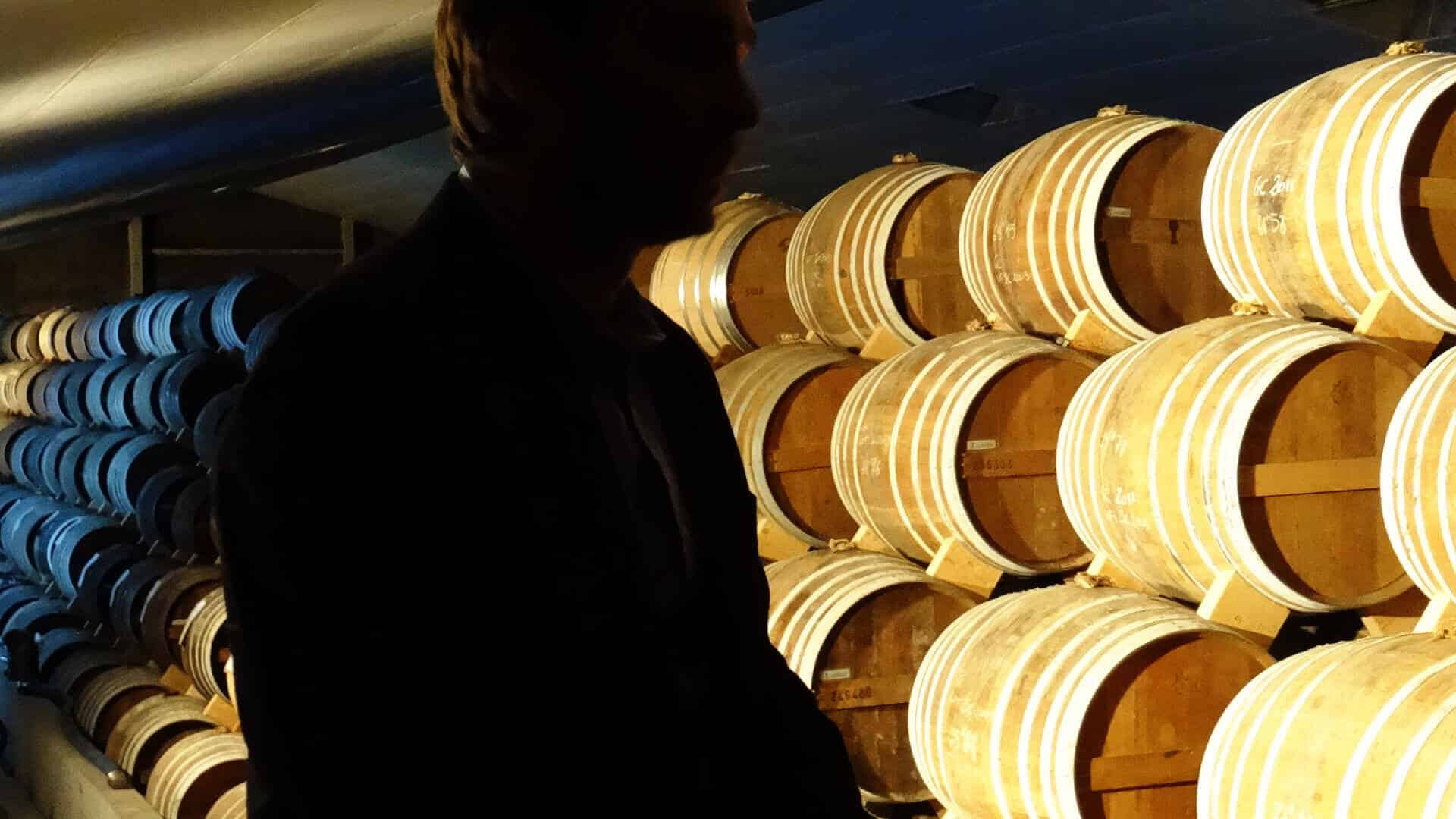 The cellar master in his domain, checking the aging of the brandies